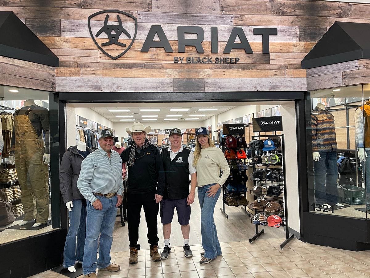Group standing at the entrance of the Ariat by Black Sheep showroom at the Silver Lake Mall.