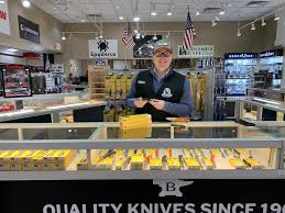 Black Sheep Knives showroom with a staff member behind a glass knife case.