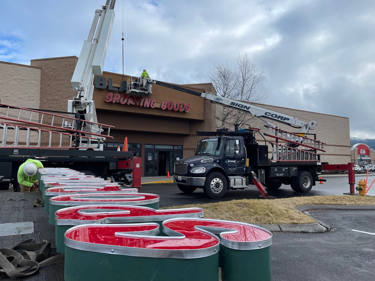 Sign crew installing the Black Sheep Sporting Goods sign at the Silver Lake Mall.